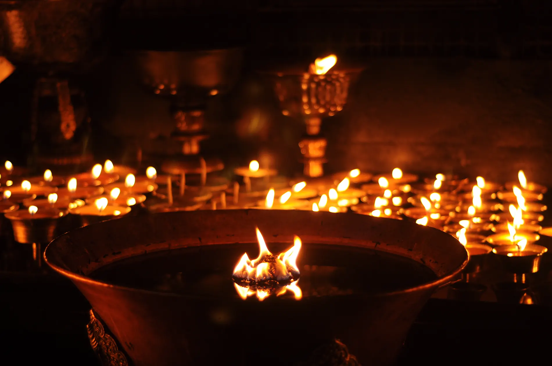 butter lamps with flames near bodhnath stupa in ka utc